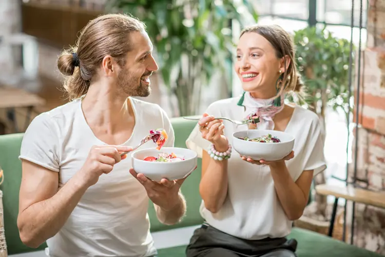 Couple enjoying a healthy meal together — consistent meal timing supports gut health in IBS
