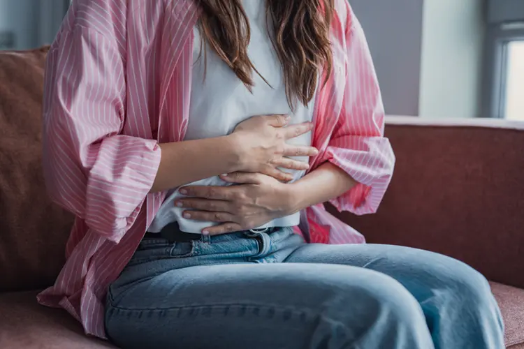 Woman experiencing IBS abdominal pain and bloating