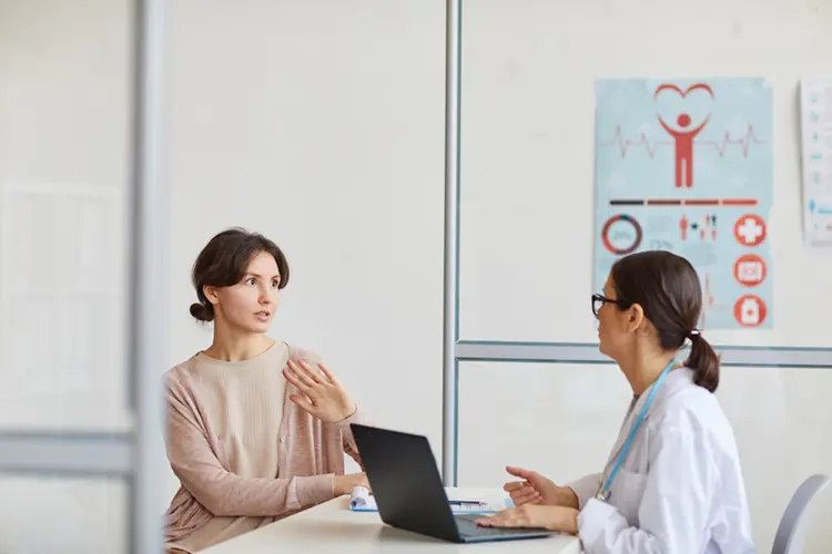 Woman discussing IBS symptoms with a GP
