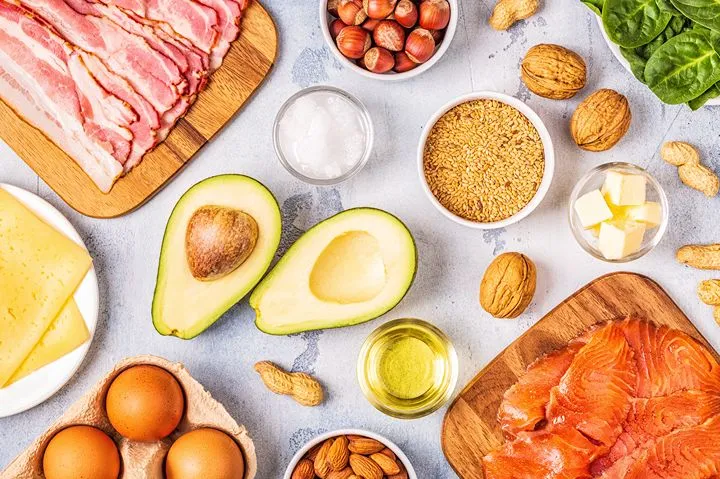 Ketogenic diet foods — avocado, eggs, salmon, bacon, nuts and cheese